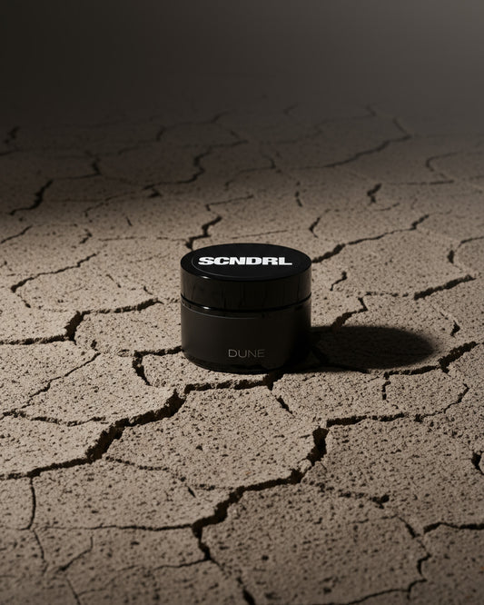 Black container with 'SCNDRL' branding on a cracked surface