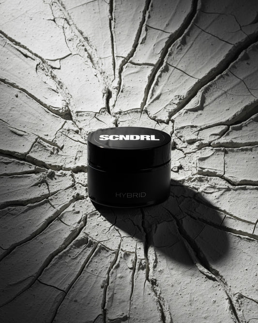 Black container with 'SCNDRL' branding on a cracked concrete surface