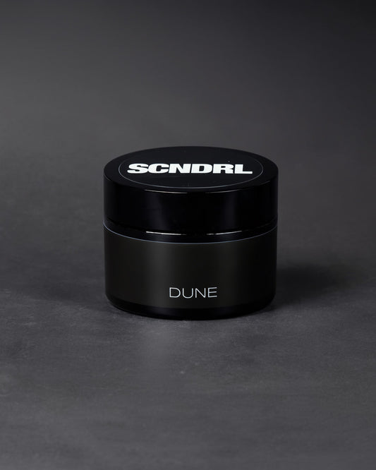 Black container with 'SCNDRL' and 'DUNE' branding on a dark gray background